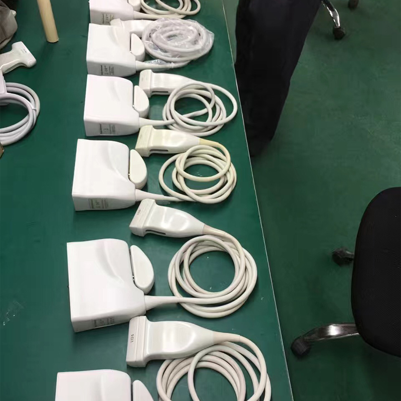 Linear array ultrasound probes arranged on the workshop bench before testing