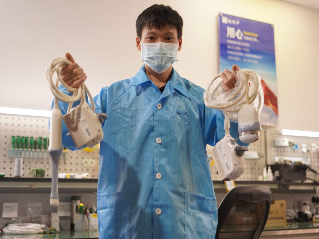 Ultrasound Probe Repair 1 Ultrasound Probe Supplier Akicare technician holding two ultrasound probes at the repair bench in Shenzhen, China